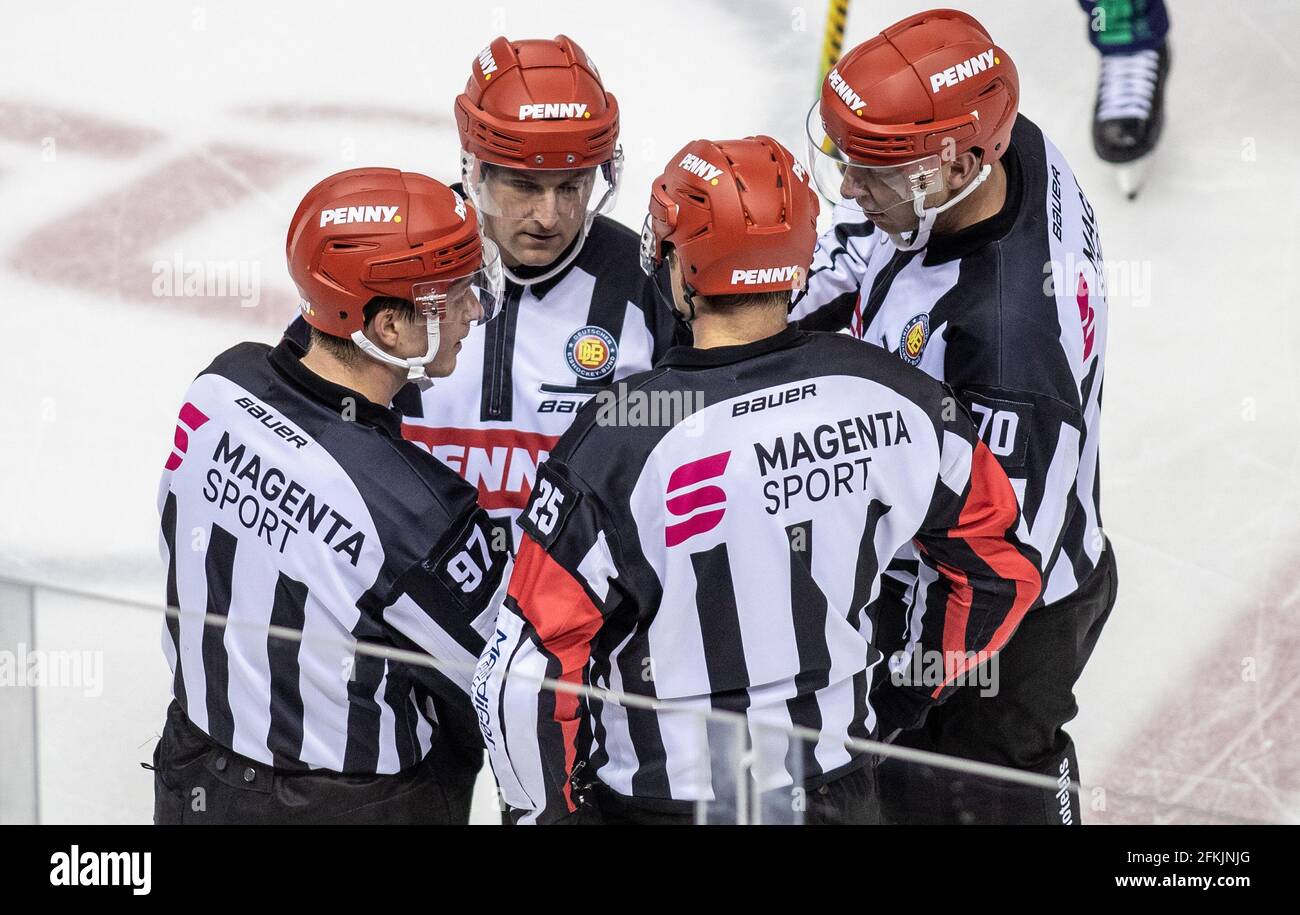 Berlin, Germany. 02nd May, 2021. Ice hockey, DEL, Eisbären Berlin - Grizzlies Wolfsburg, Championship Round, Final, Game Day 1, Mercedes-Benz Arena: Referee Marius Wölzmüller (l-r), Marian Rohatsch, Aleksi Rantala and Joep Leermakers discuss on the ice. Credit: Andreas Gora/dpa/Alamy Live News Stock Photo