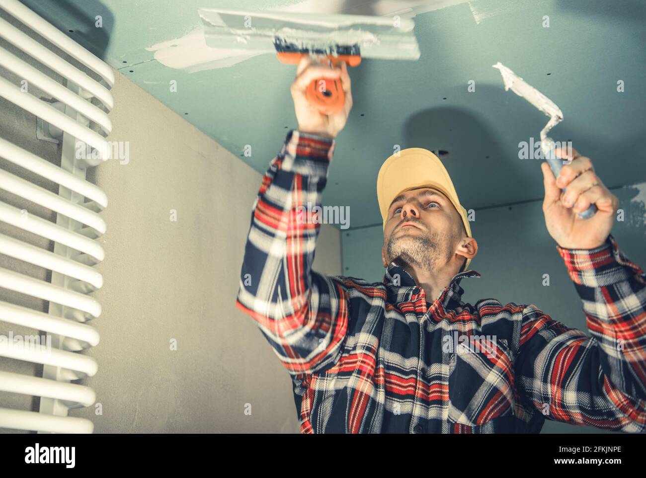 Caucasian Construction and Remodeling Worker in His 40s Patching