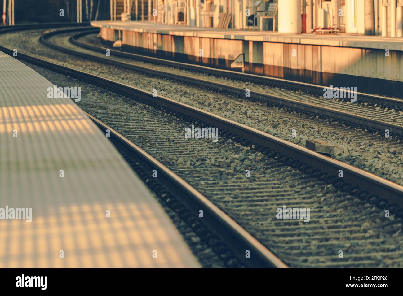 Modern Railroad Platform and Tracks Close Up. Rail Transportation Theme. Stock Photo