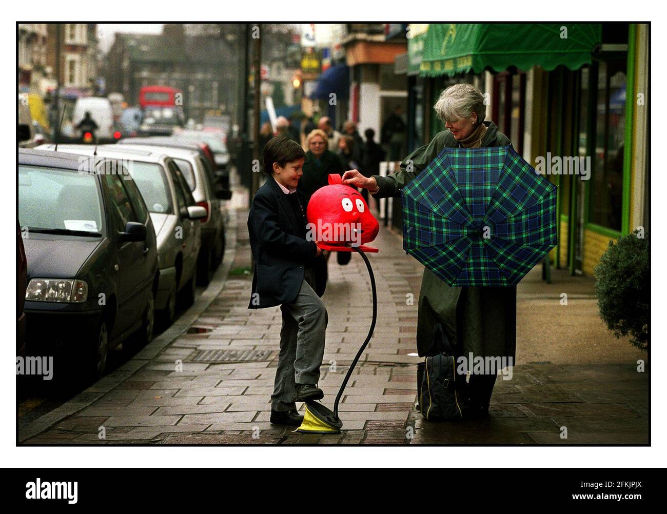 Eleven year old Edmund Cuthbert of Herne Hill gladly recieves a donation for Red Nose day. He has used his own initiative and ability to build a selection of donation boxes. he or his mother can be contacted on 0207 737 3269. Stock Photo