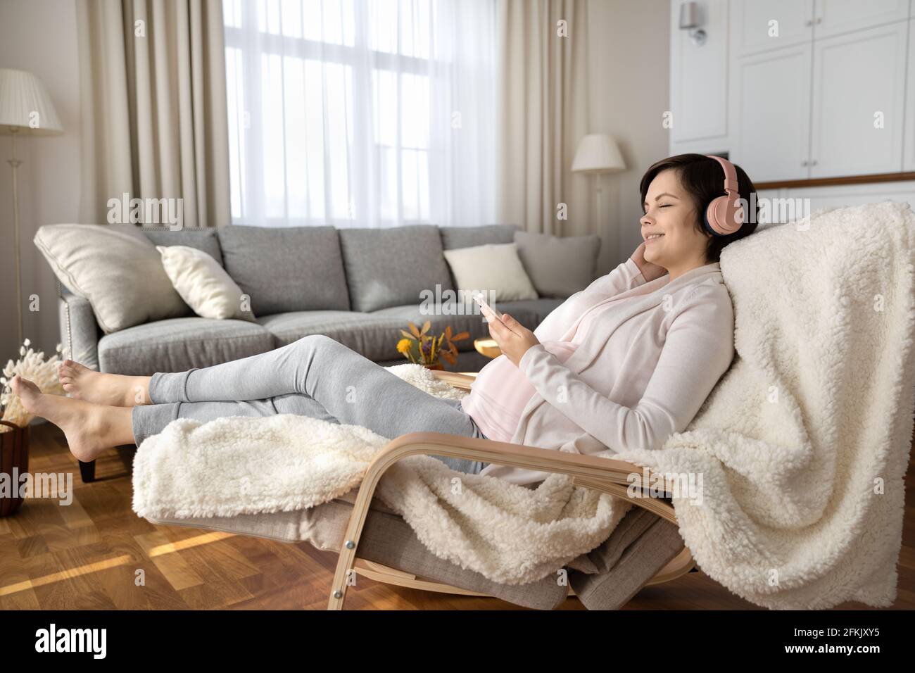 Happy pregnant woman listen to music in headphones Stock Photo - Alamy