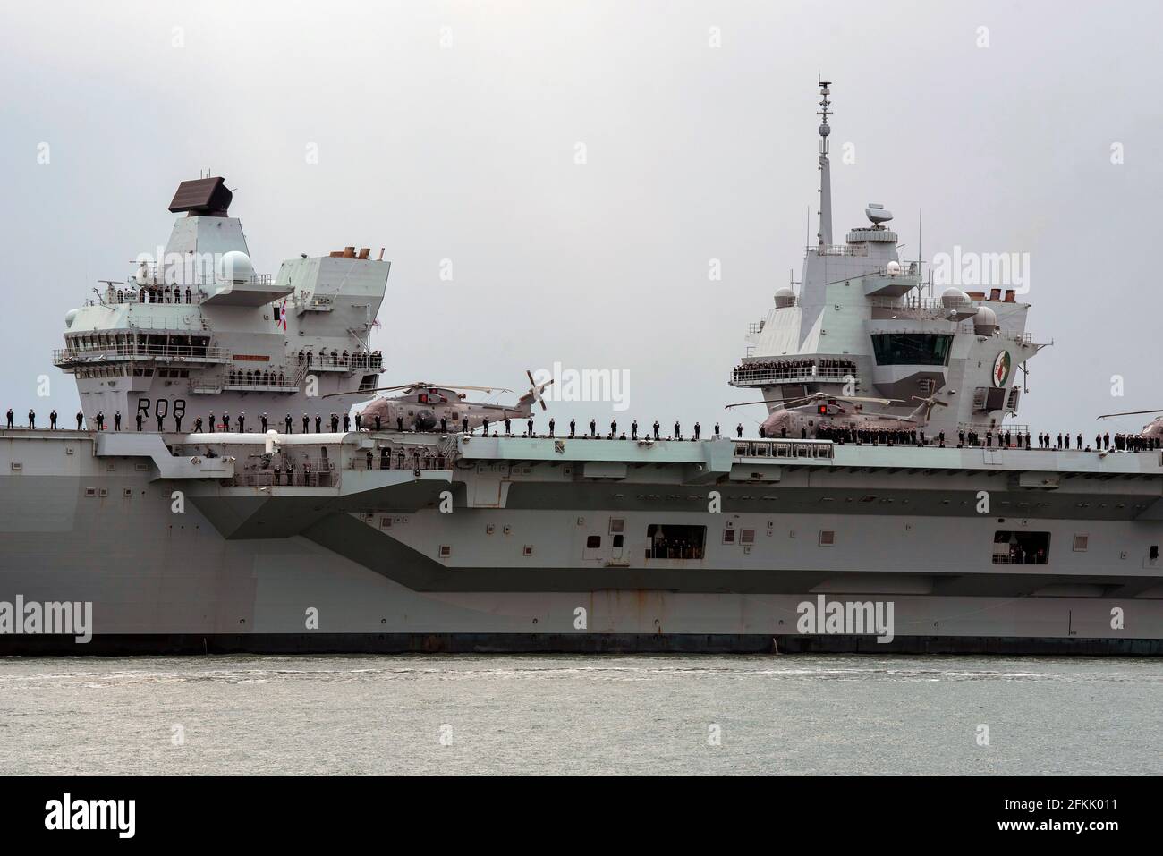 Portsmouth, England, UK. 2021. HMS  Queen Elizabeth  deaparting on her  maiden deployment with crew on deck. Aft command tower for air operations and Stock Photo