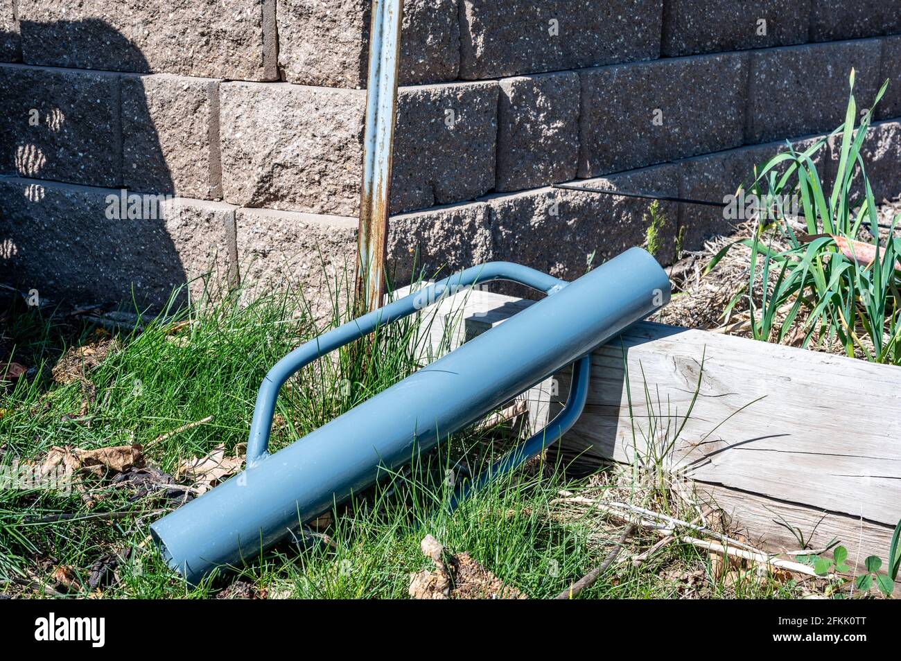 Manual fence post driver that is used by placing over a metal rod and