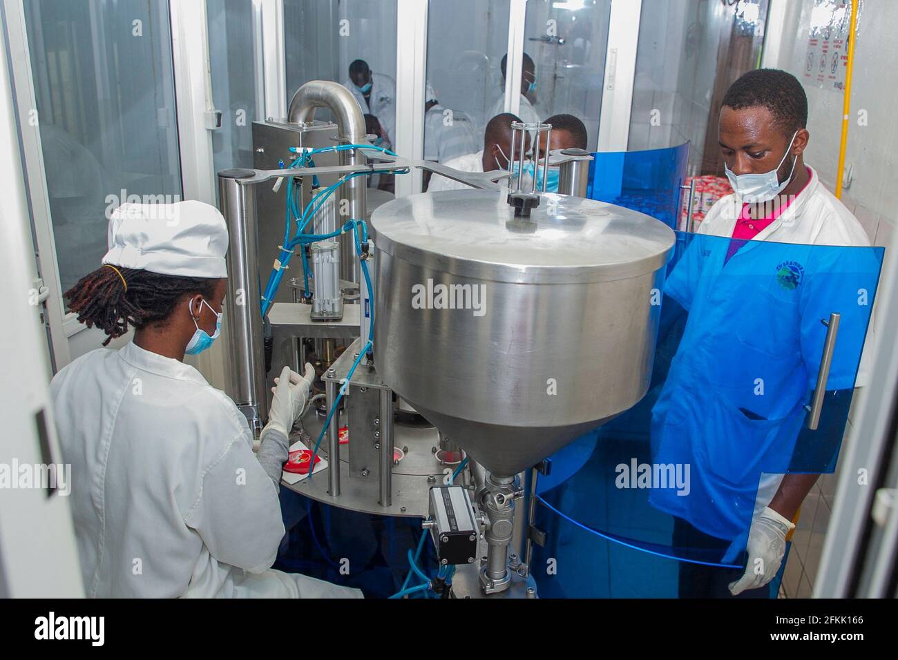 (210502) -- NYANZA, May 2, 2021 (Xinhua) -- Technicians package yogurt at Zirakamwa Meza Dairy in Nyanza district, about a two-hour drive from the Rwandan capital city Kigali, on April 30, 2021. TO GO WITH 'Feature: From genocide widow to successful businesswoman -- Rwandan woman walking out of shadow' (photo by Cyril Ndegeya/Xinhua) Stock Photo