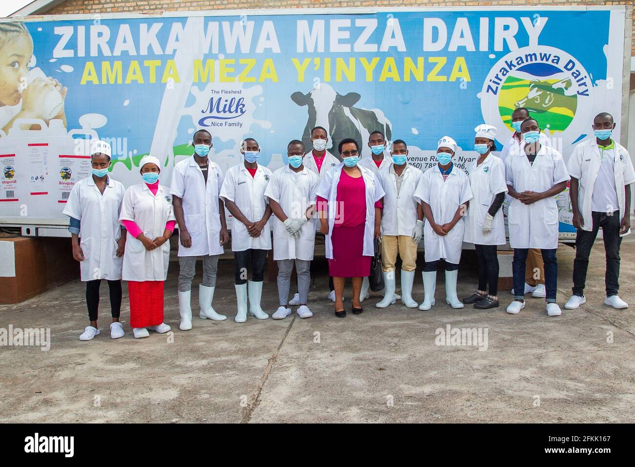 (210502) -- NYANZA, May 2, 2021 (Xinhua) -- Immaculee Kayitesi (C), owner of Zirakamwa Meza Dairy, poses for a group photo with employees of her company in Nyanza district, about a two-hour drive from the Rwandan capital city Kigali, on April 30, 2021. TO GO WITH 'Feature: From genocide widow to successful businesswoman -- Rwandan woman walking out of shadow' (photo by Cyril Ndegeya/Xinhua) Stock Photo