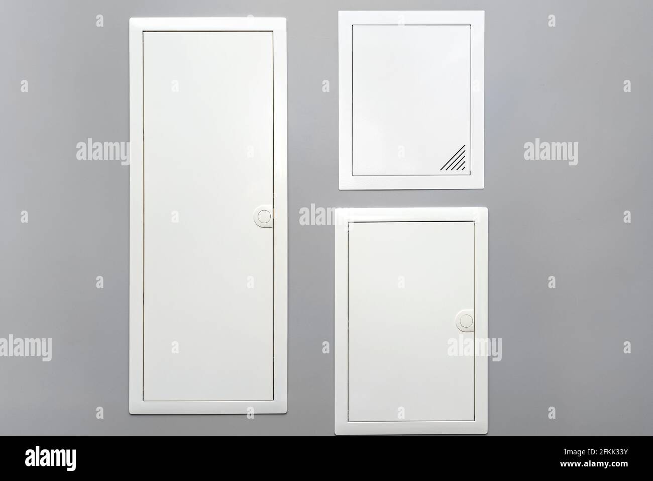 Two closed electrical boxes with fuses and one multimedia box, placed