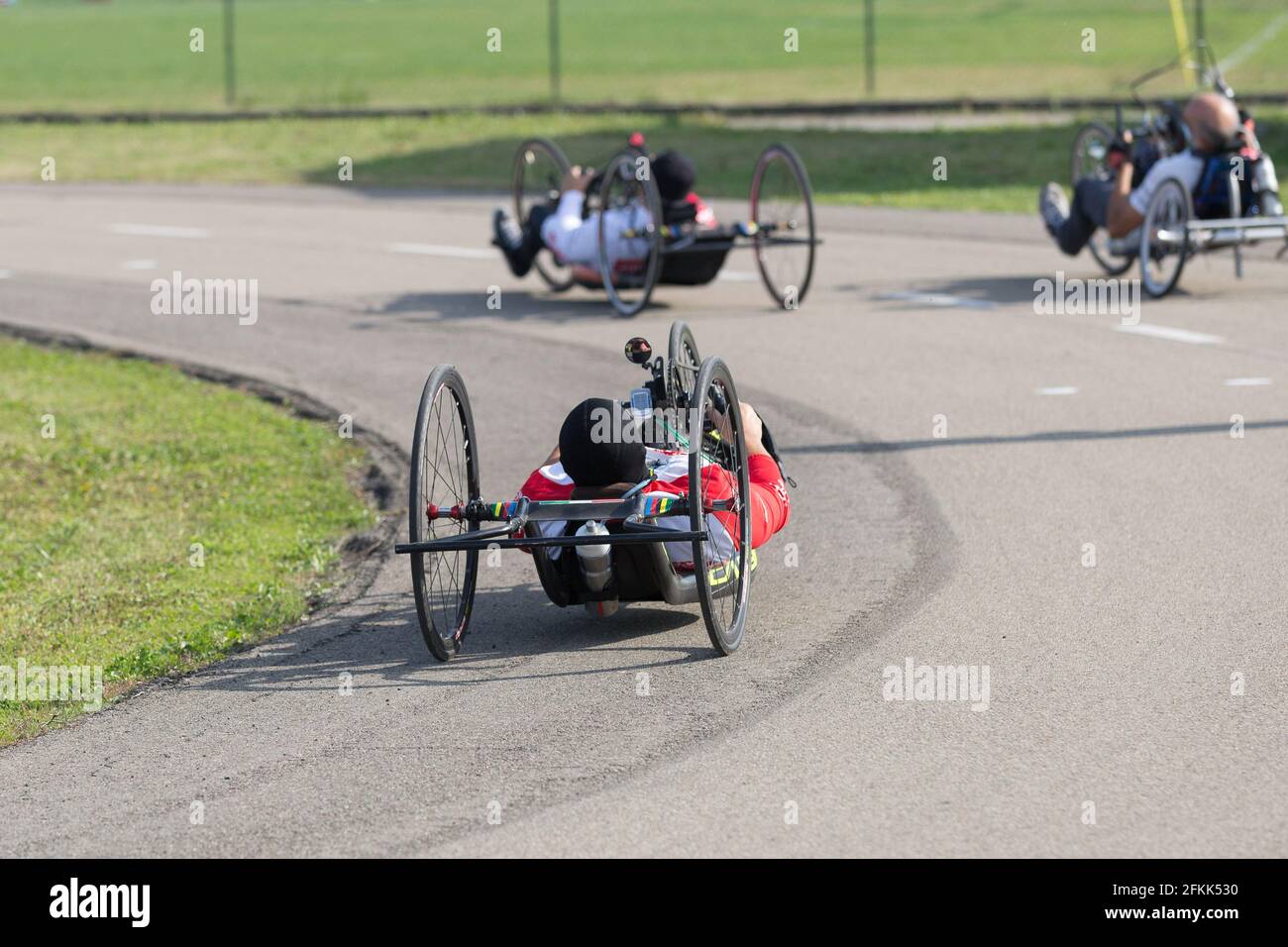 Disabled Athletes training with Their Hand bikes on a Track Stock Photo