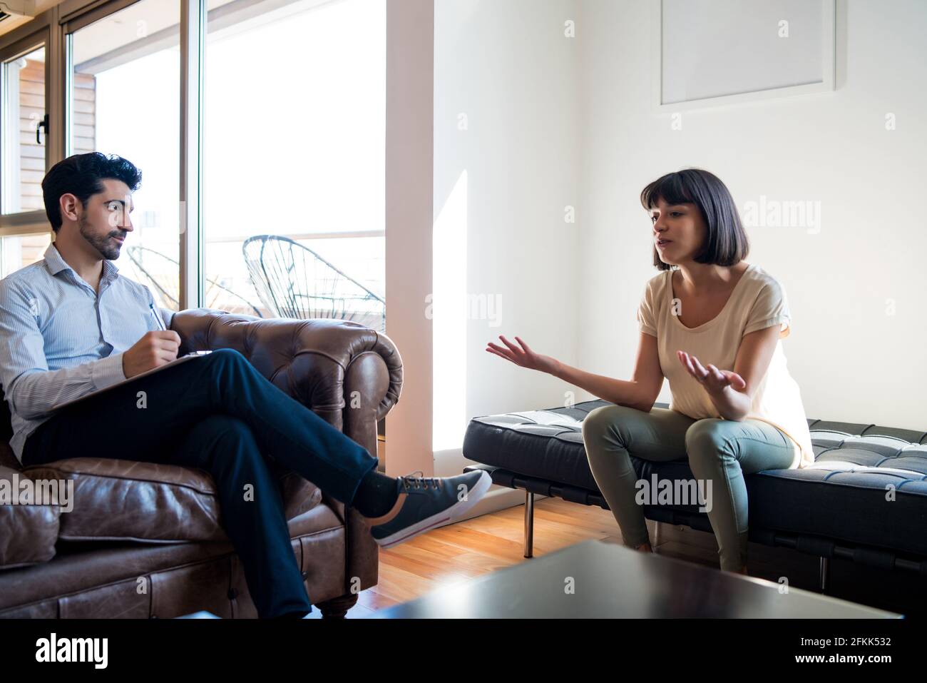 Psychologist talking with patient on therapy session Stock Photo Alamy