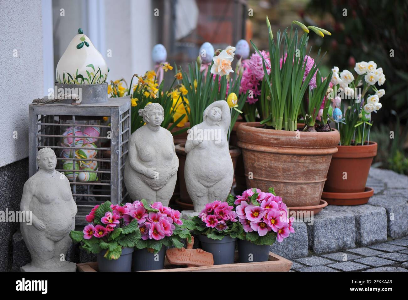 House entrance garden decoration with spring flowers: primroses, hyacinths and daffodils Stock Photo
