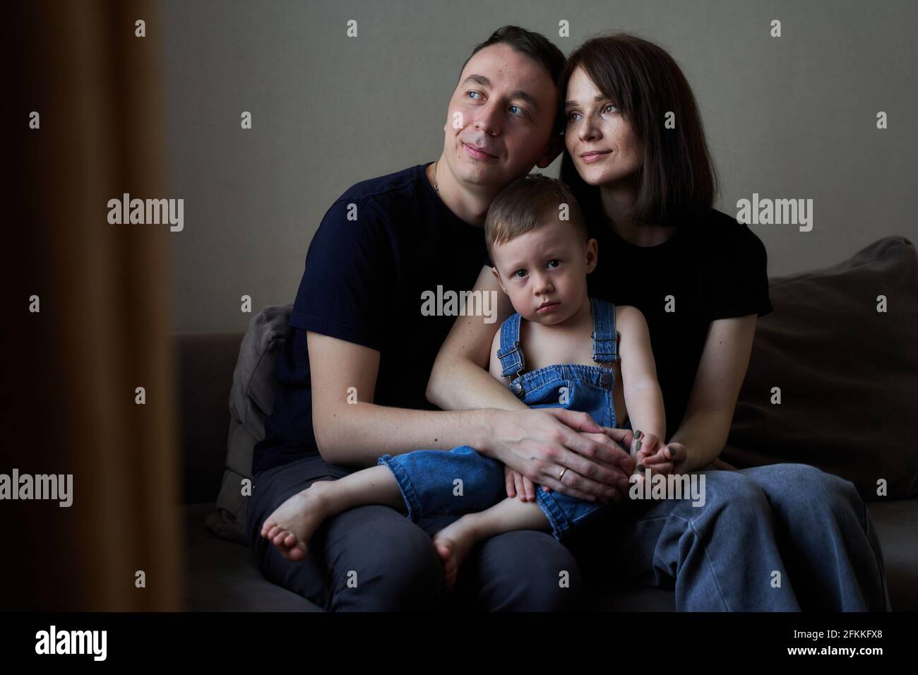 a family of mom dad and baby at home Stock Photo - Alamy