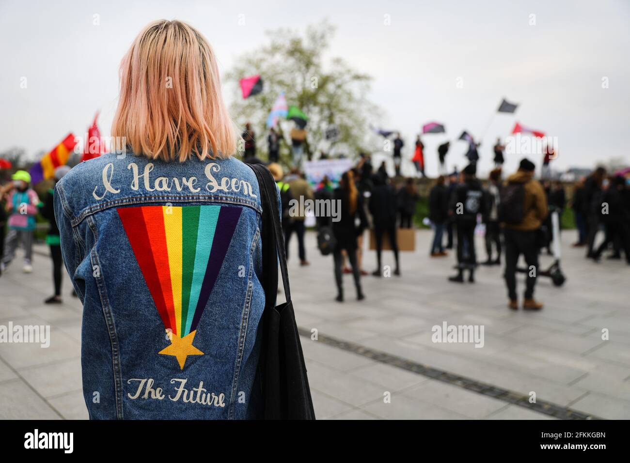 Slogan 'I have seen the future' and the LGBTQ symbol is seen on the back of a member of LGBTQ community during the demonstration.International Workers' Day, also known as Labour Day or May Day has a long tradition in Poland. Before the fall of communism, propaganda events were held on this day, it is now a day for young adults with left-wing views to express their reservations about the labour market and the lack of social justice it entails, as forcing workers into self-employment and abuses of labour rights are common practices in Poland. Stock Photo