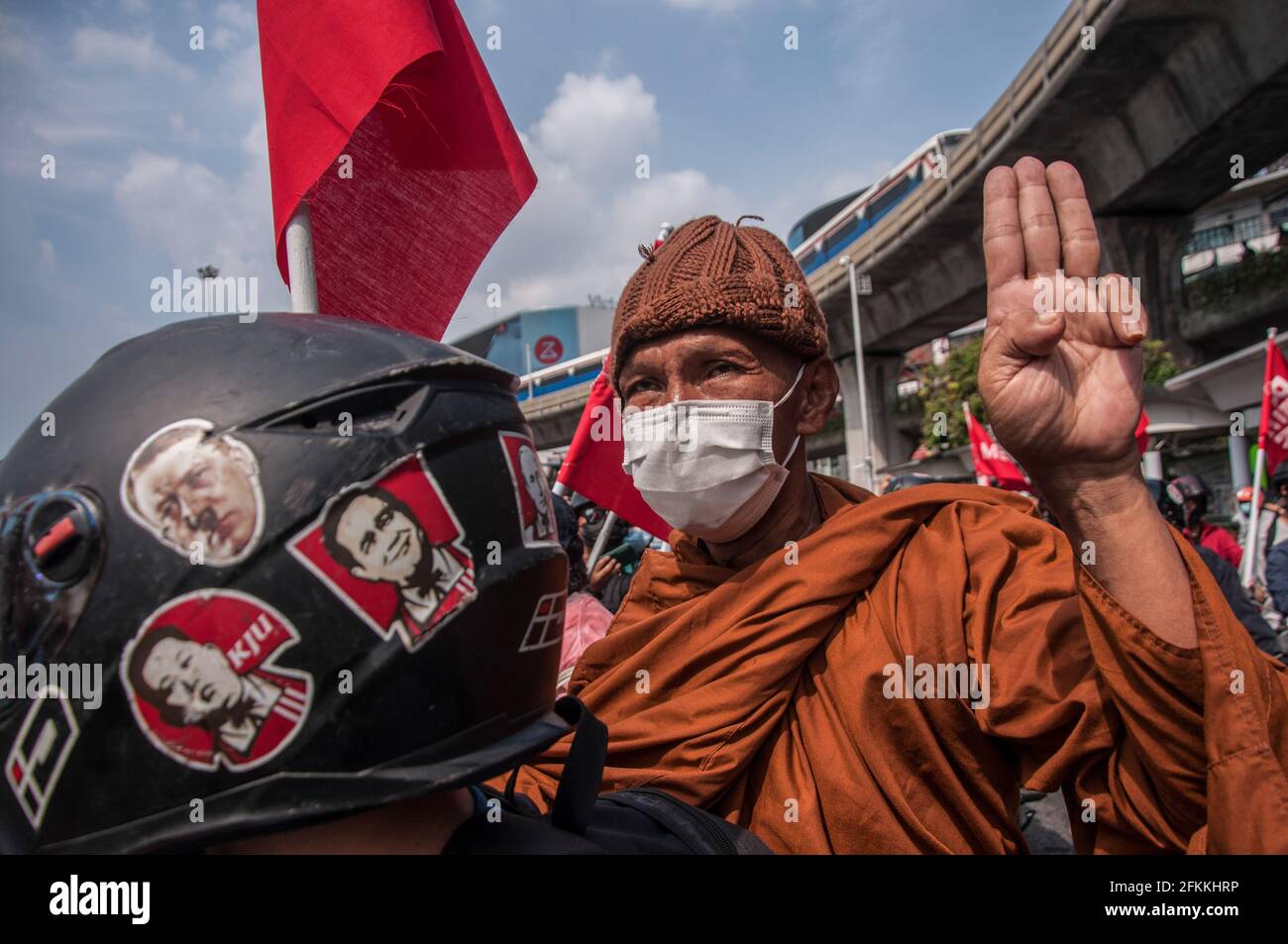 Bangkok, Thailand. 02nd May, 2021. A Buddhist monk makes three finger salute during the demonstration. The pro-democracy protesters led by 'REDEM' group gather at the Victory Monument before going by vehicle to the Criminal Court of Thailand to demand the release of detained pro-democracy activists who were detained by the lese majeste law (article 112 of the Thai criminal code). Credit: SOPA Images Limited/Alamy Live News Stock Photo