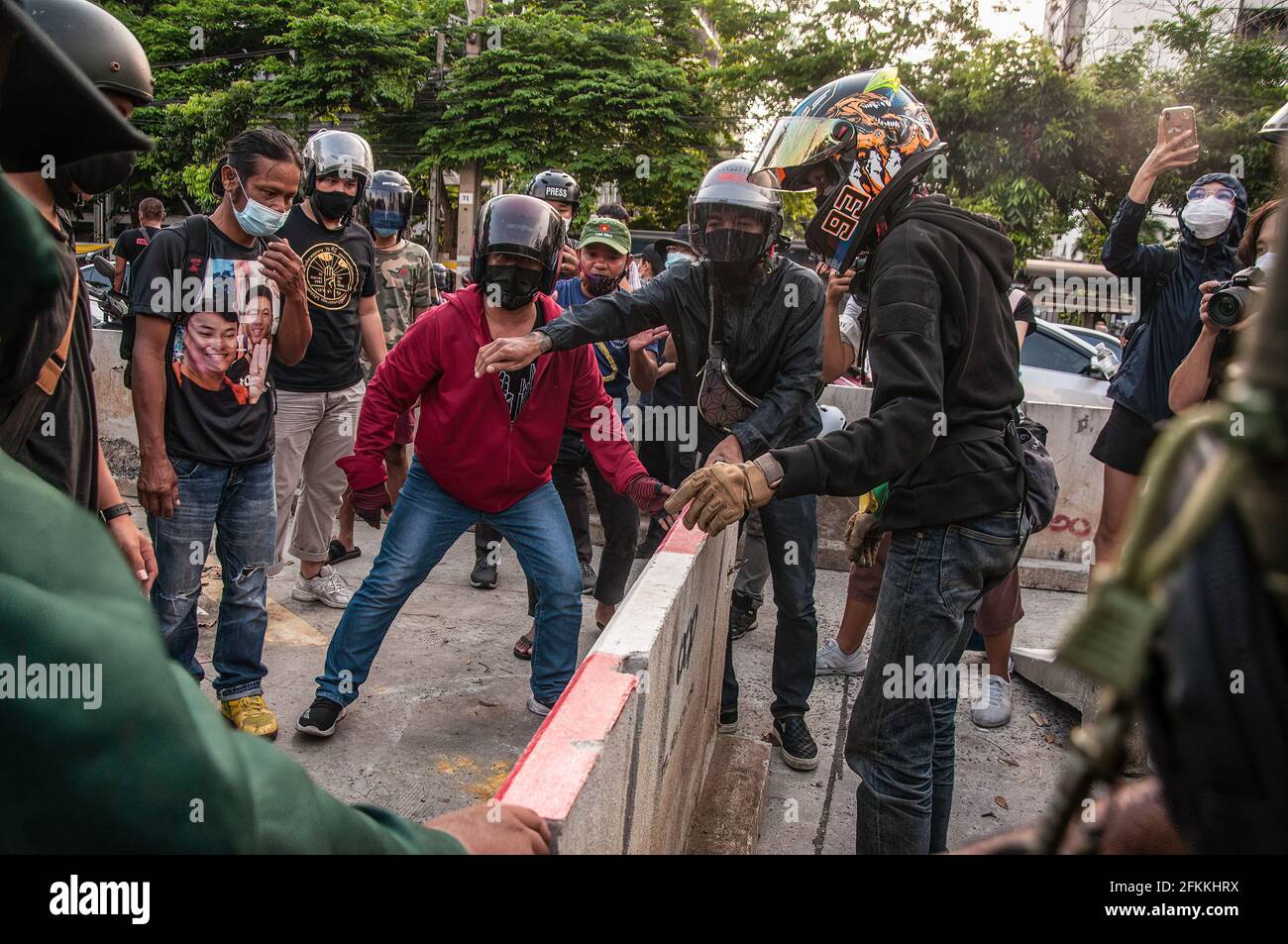 Bangkok, Thailand. 02nd May, 2021. Pro-democracy protesters try to move the barrier during the demonstration. The pro-democracy protesters led by 'REDEM' group gather at the Victory Monument before going by vehicle to the Criminal Court of Thailand to demand the release of detained pro-democracy activists who were detained by the lese majeste law (article 112 of the Thai criminal code). Credit: SOPA Images Limited/Alamy Live News Stock Photo