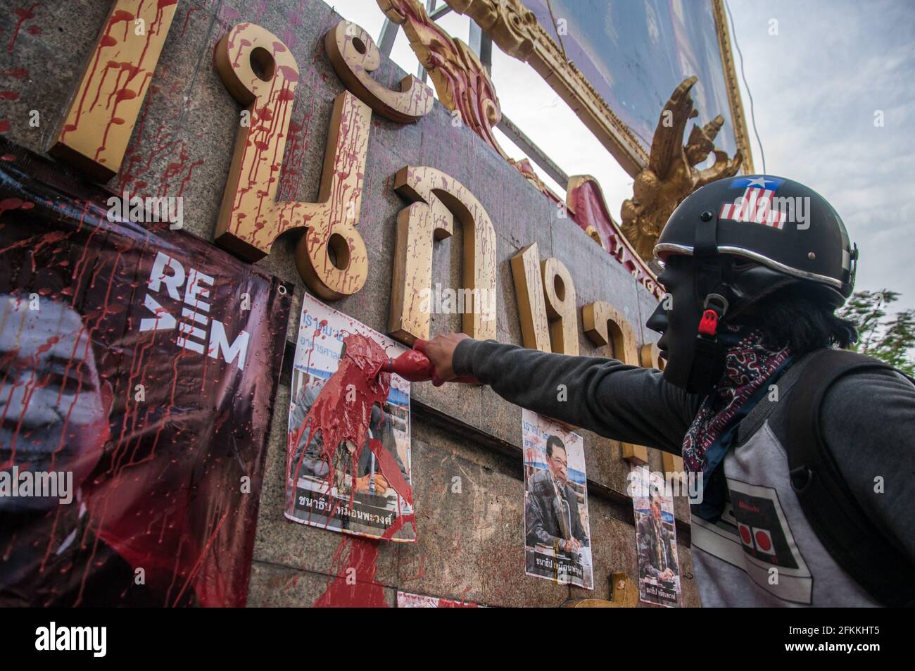 Bangkok, Thailand. 02nd May, 2021. A protester pours red paint at the portrait of Chanathip Muanpawong the Deputy Chief Justice during the demonstration. The pro-democracy protesters led by 'REDEM' group gather at the Victory Monument before going by vehicle to the Criminal Court of Thailand to demand the release of detained pro-democracy activists who were detained by the lese majeste law (article 112 of the Thai criminal code). Credit: SOPA Images Limited/Alamy Live News Stock Photo