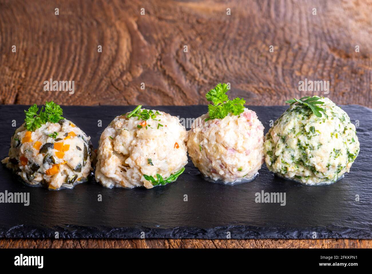 four different dumplings on slate Stock Photo