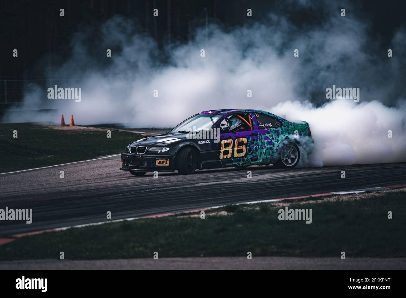 Car drifting, Blurred of image diffusion race drift car with lots of smoke  from burning tires on speed track Stock Photo