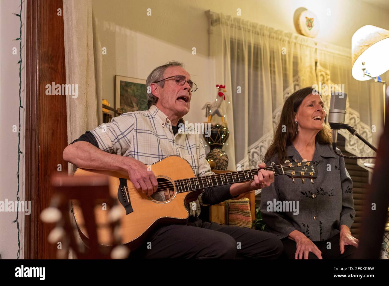 Detroit, Michigan - Bob O'Brien and Julie Beutel perform a home concert by Zoom during the coronavirus pandemic. People could watch the concert for fr Stock Photo