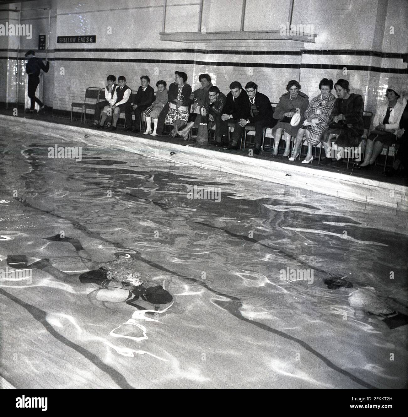 1960s, historical, at a swimming baths, parents and school children