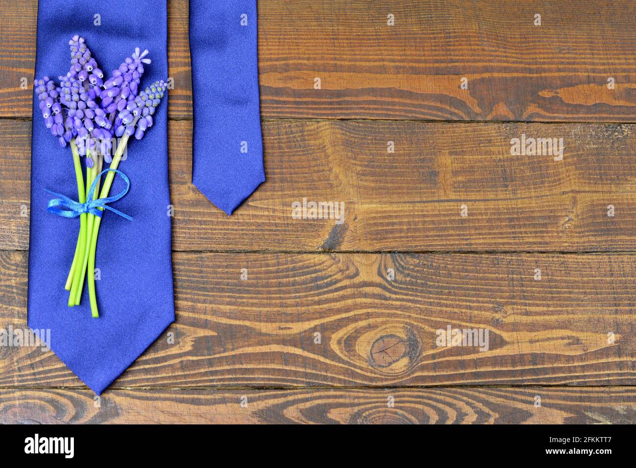 Fathers Day background with blue tie and grape hyacinth flowers Stock Photo