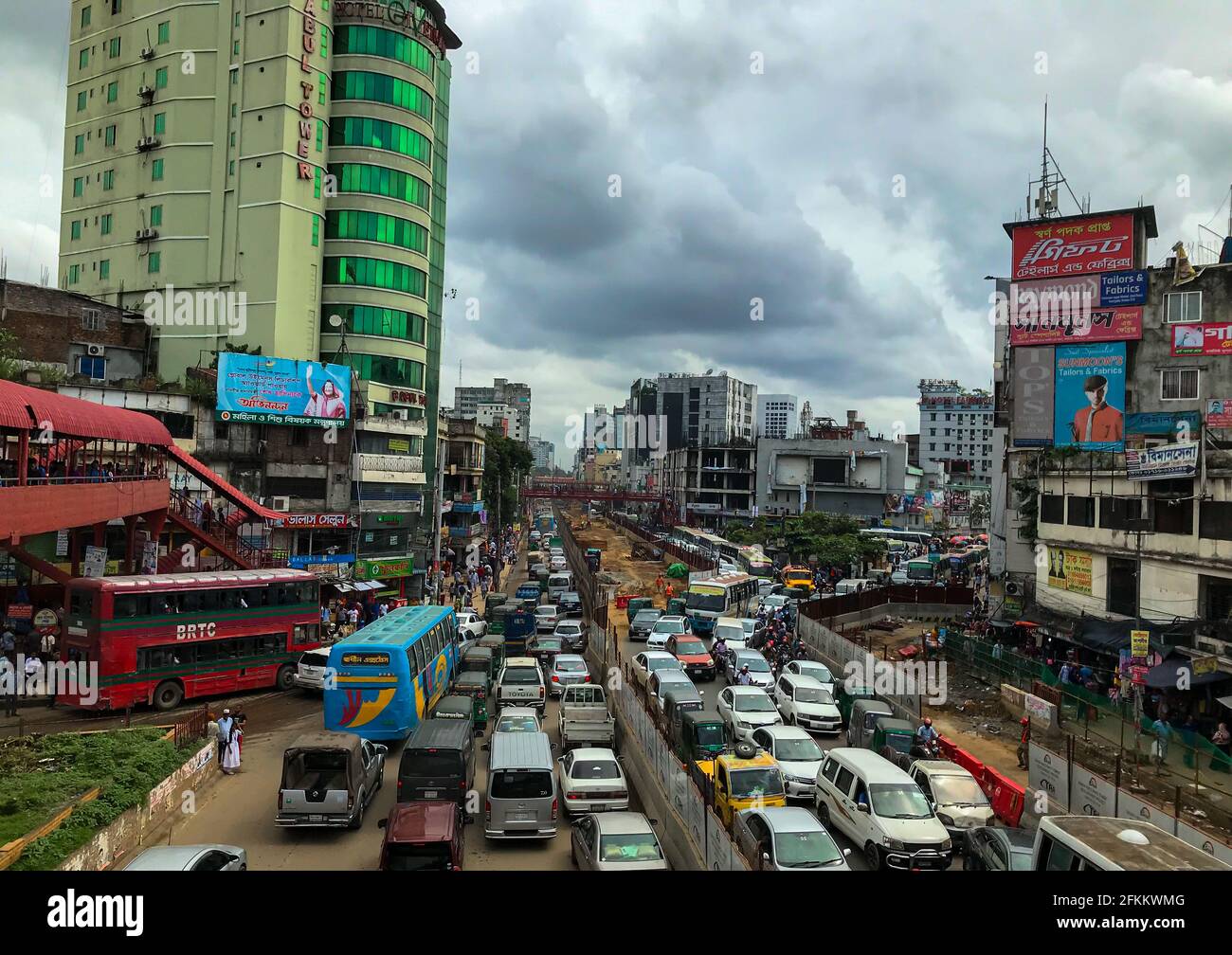 Dhaka , Bangladesh - 9 December 2019 ; road full of traffic and dark cloudy sky . Dhaka Metro Rail project started . Stock Photo