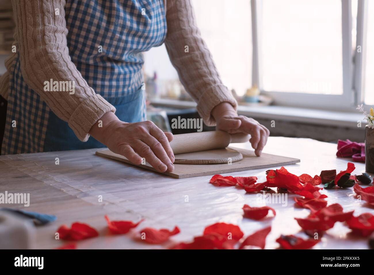 Senior female artisan creating handmade ceramics in pottery studio Stock Photo