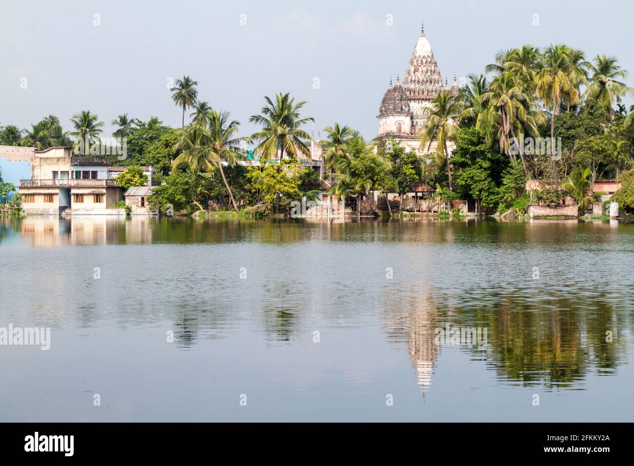 Shiva temple reflecting in a pond in Puthia village, Bangladesh Stock Photo