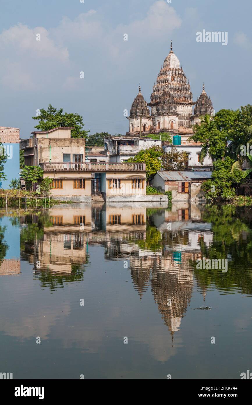 Shiva temple reflecting in a pond in Puthia village, Bangladesh Stock Photo