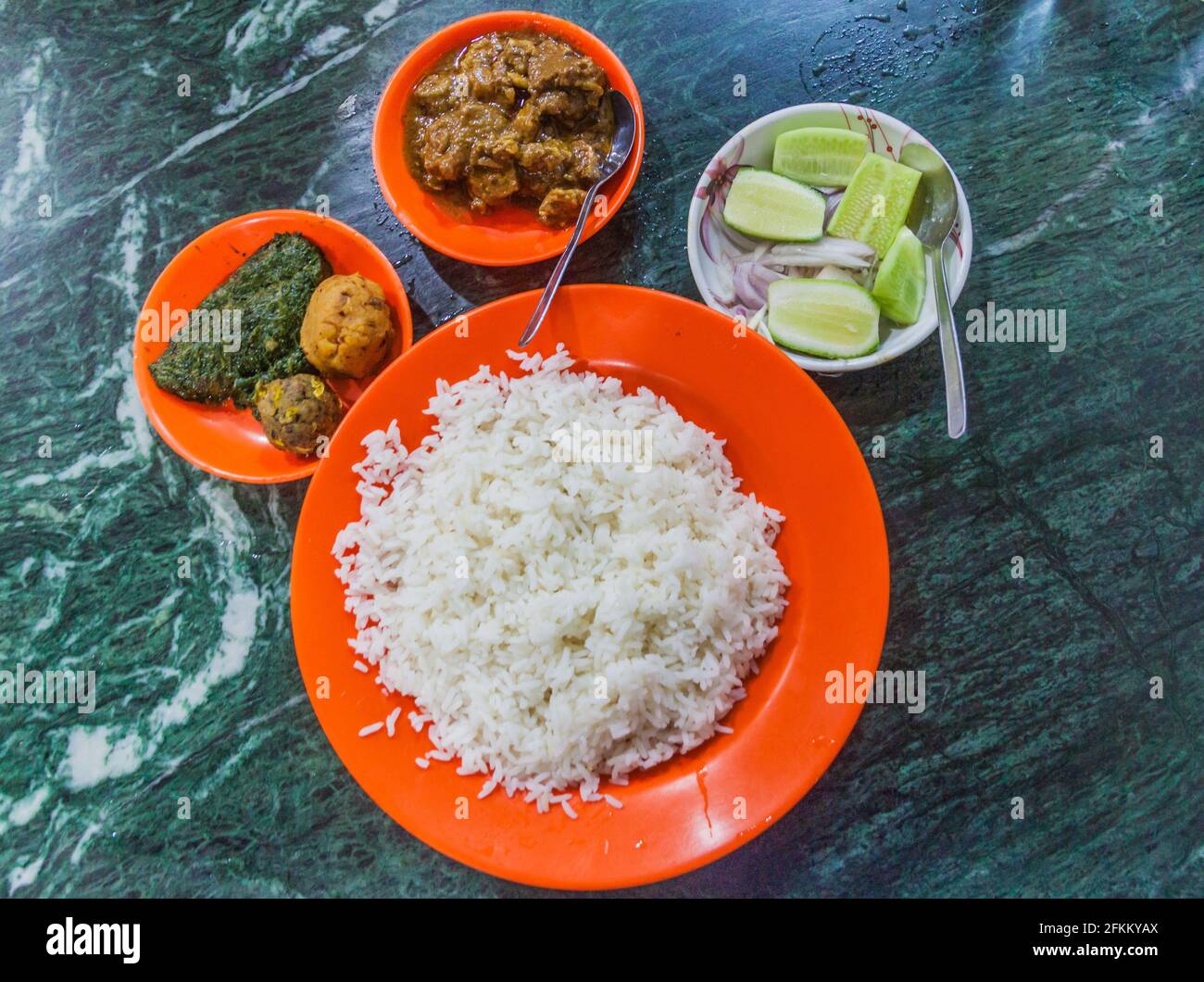 Meal in Bangladesh - Rice, Alo vorta, Shim borta and chicken curry Stock Photo