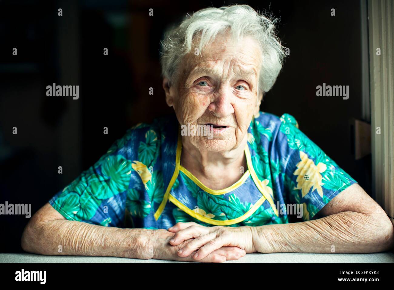 Portrait of an old slavic woman in her home. Stock Photo