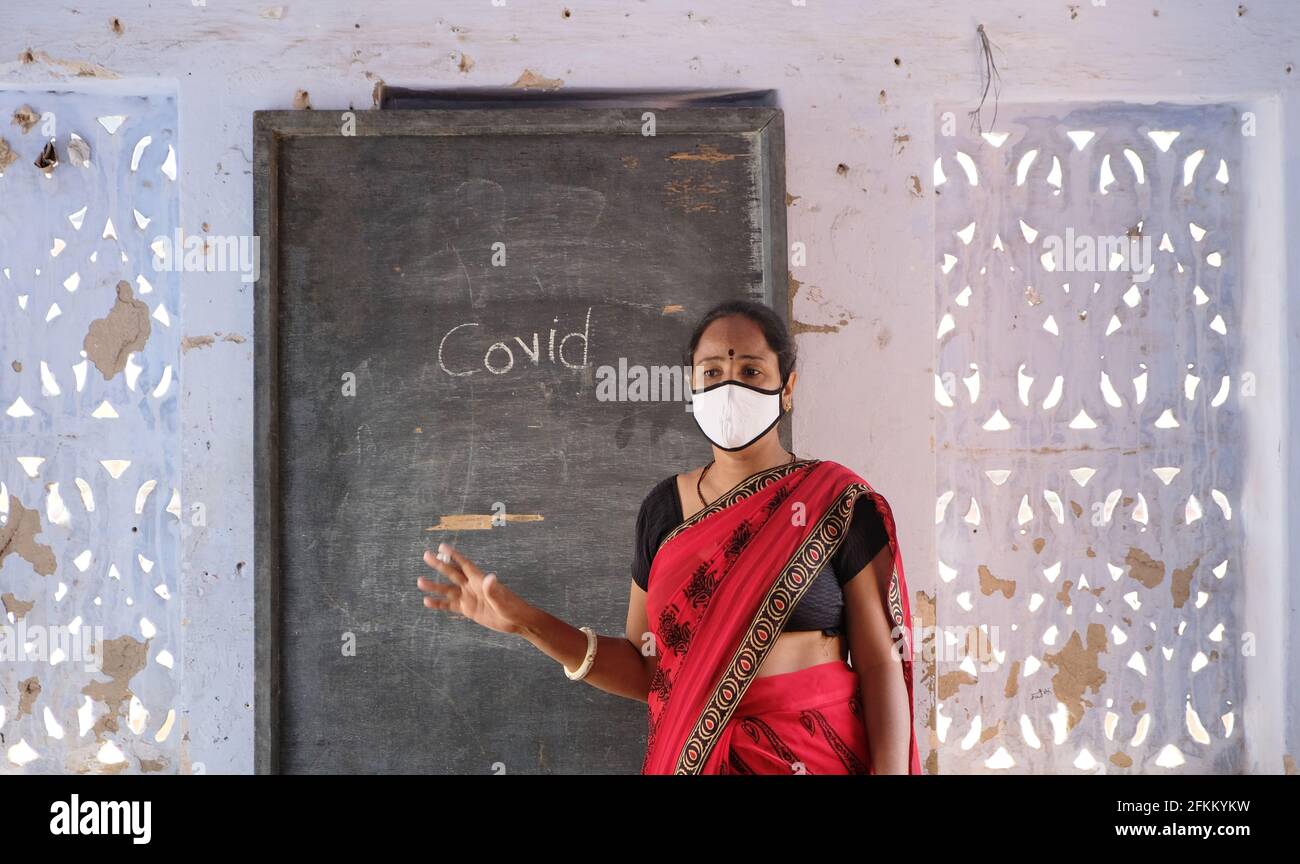 An Indian female teacher in face mask at school during Covid-19 ...