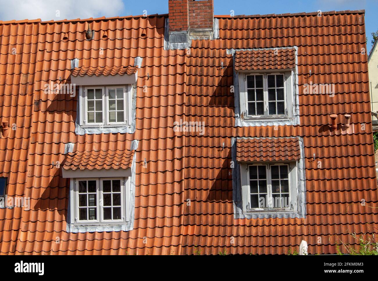 An old building with red shingles roofing design Stock Photo