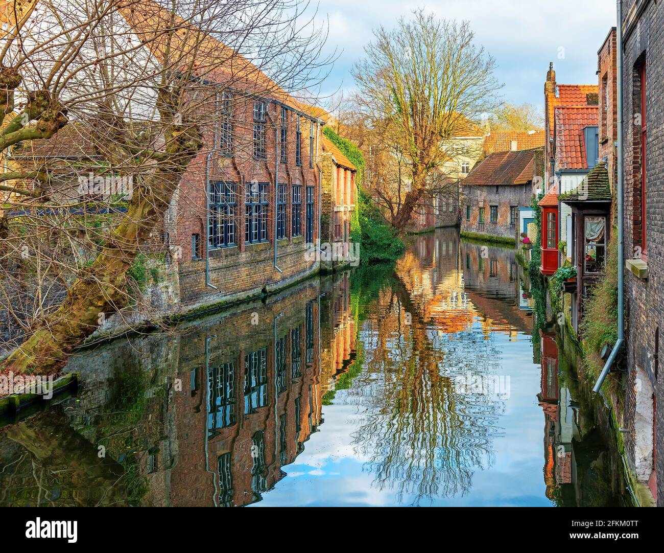 Bruges (Brugge) canal at sunset with medieval architecture, West Flanders, Belgium. Stock Photo