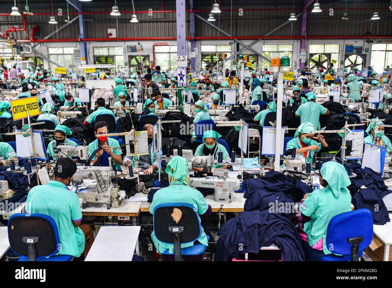 Garment workers work in a sewing section of the Fakhruddin Textile ...