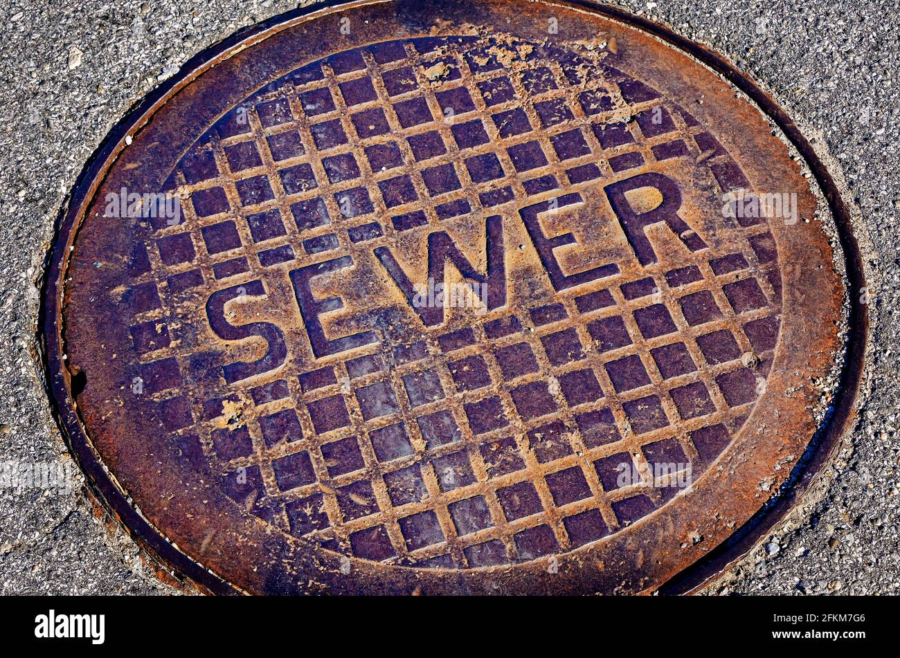 A rusted sewer lid is pictured downtown, April 25, 2021, in Moss Point, Mississippi. Stock Photo
