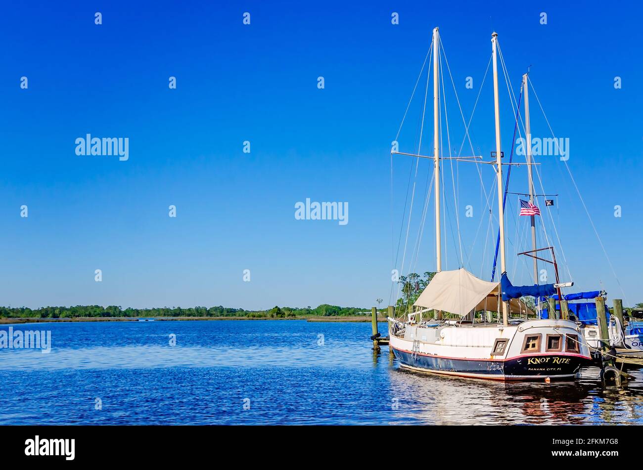 A sailboat, Knot Rite, is docked on the Escatawpa River at the