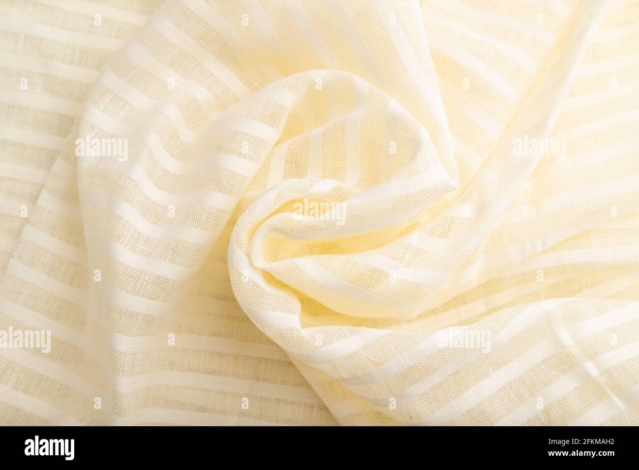 Fragment of white linen tissue. Top view, flat lay, natural textile background and texture. wave concept, abstract, spiral form. Stock Photo
