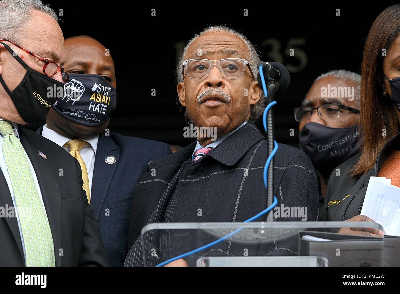 American civil rights activist Al Sharpton (at podium) is joined by (l
