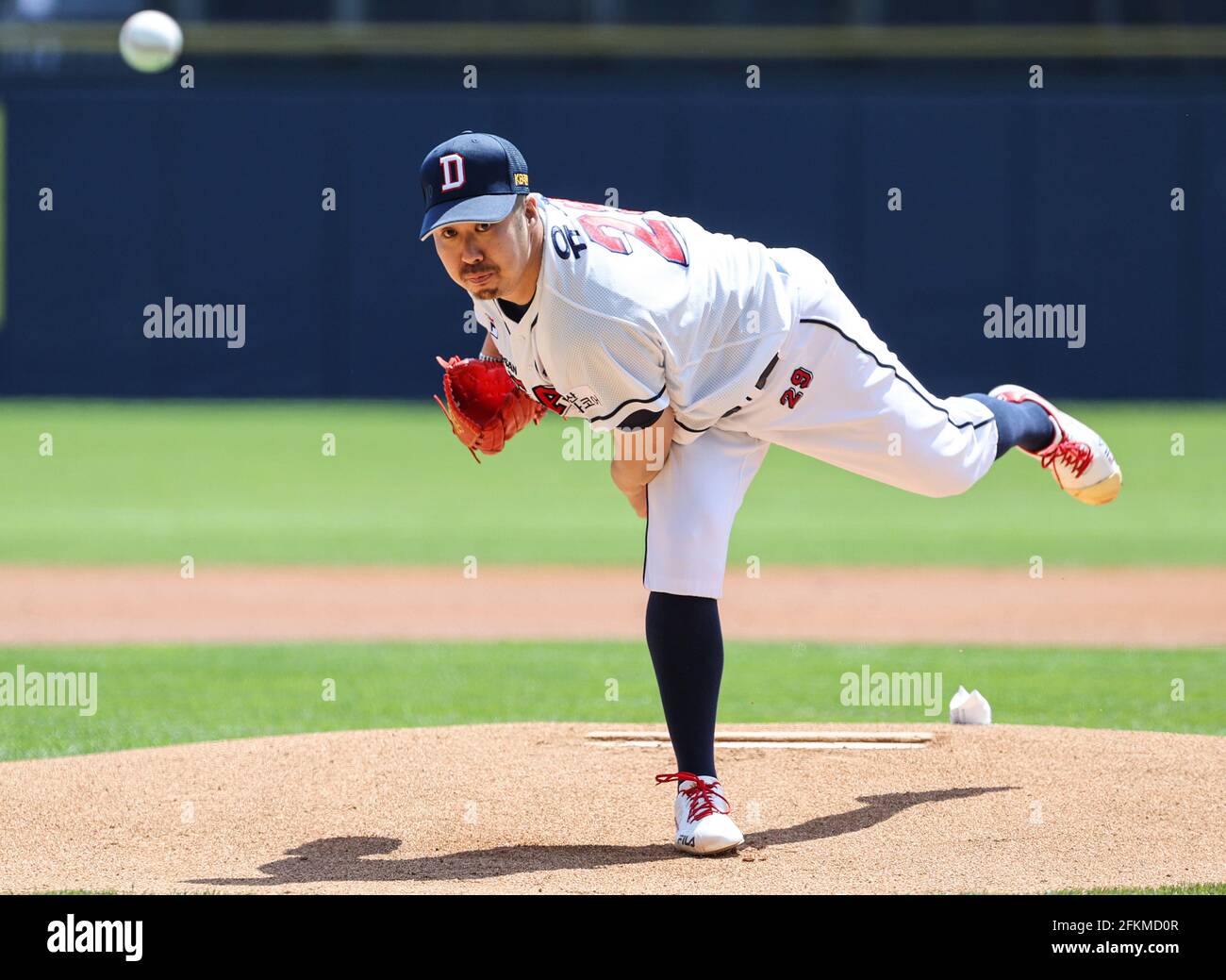 Outfielder Kim In-Tae of Doosan Bears scores a run into the home