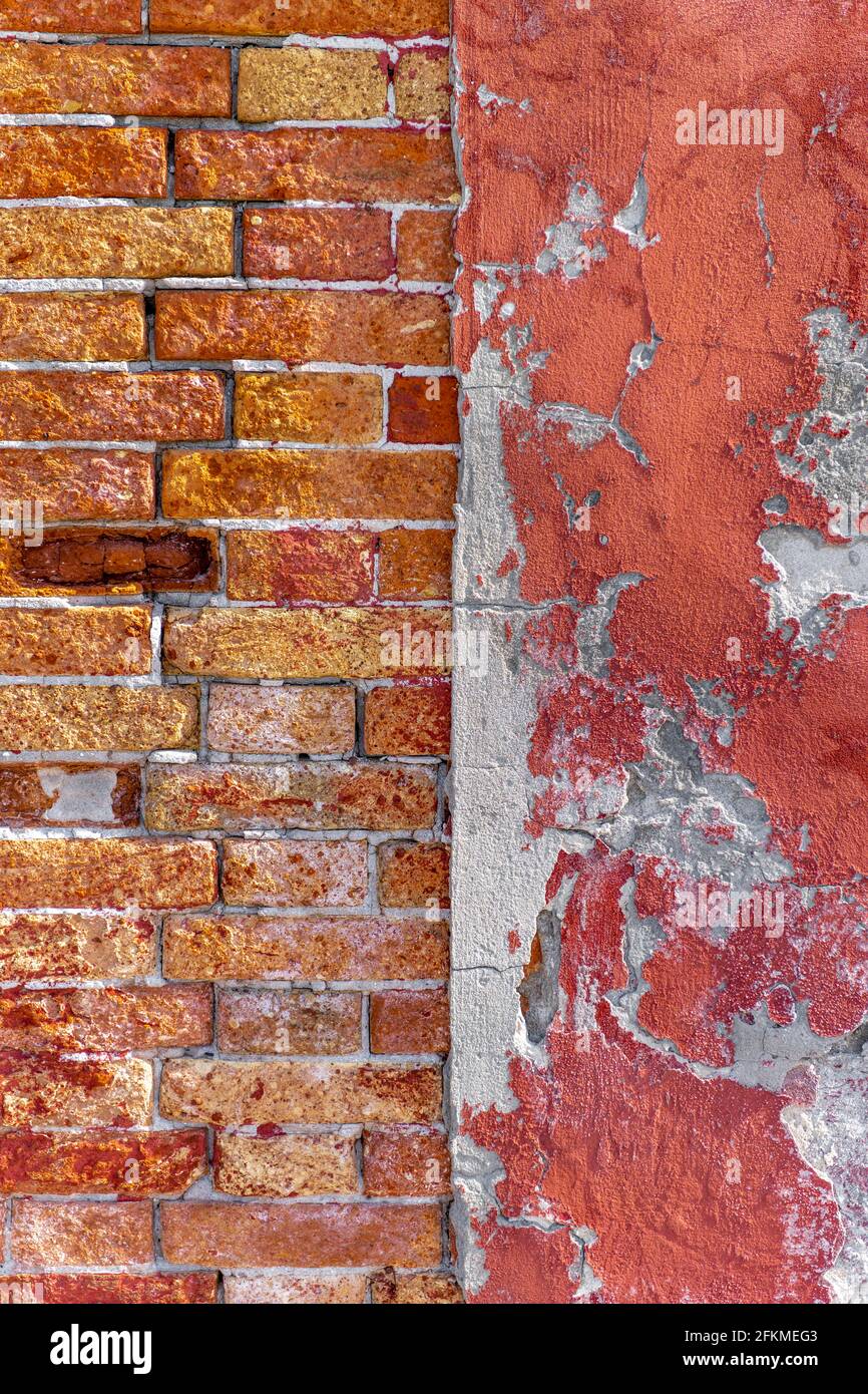 Old wall, brick wall next to red wall with crumbling paint, Venice