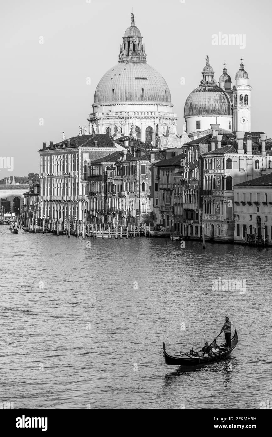 Black and white, view from the Ponte dell'Accademia to the Grand Canal with gondola, Basilica Santa Maria della Salute, Venice, Veneto, Italy Stock Photo