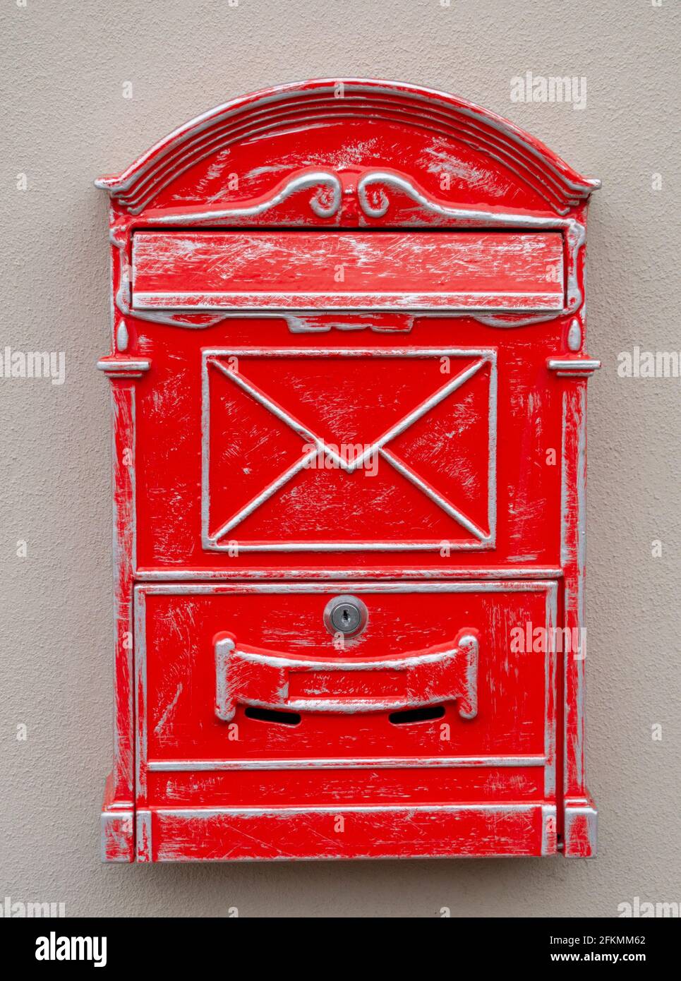 Antique red letter box or mail drop mounted on the wall. Close up