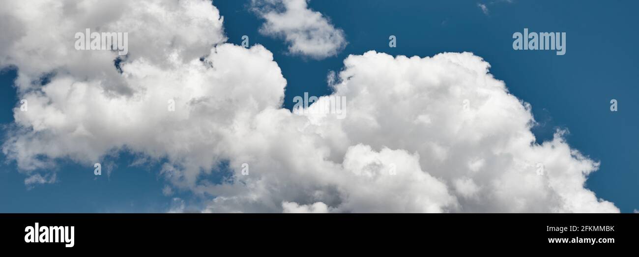 Blue sky background with a fluffy clouds Stock Photo - Alamy