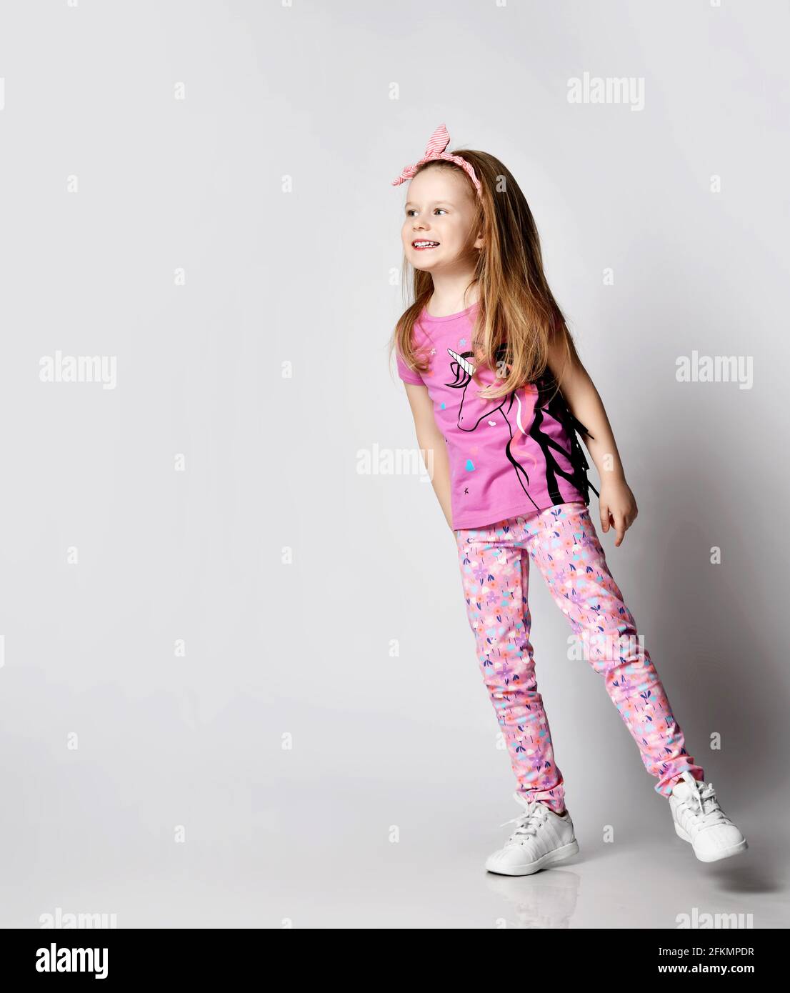 Happy Playful Blonde Kid Girl In Summer Clothing Colorful Pants And T happy-playful-blonde-kid-girl-in-summer-clothing-colorful-pants-and-t