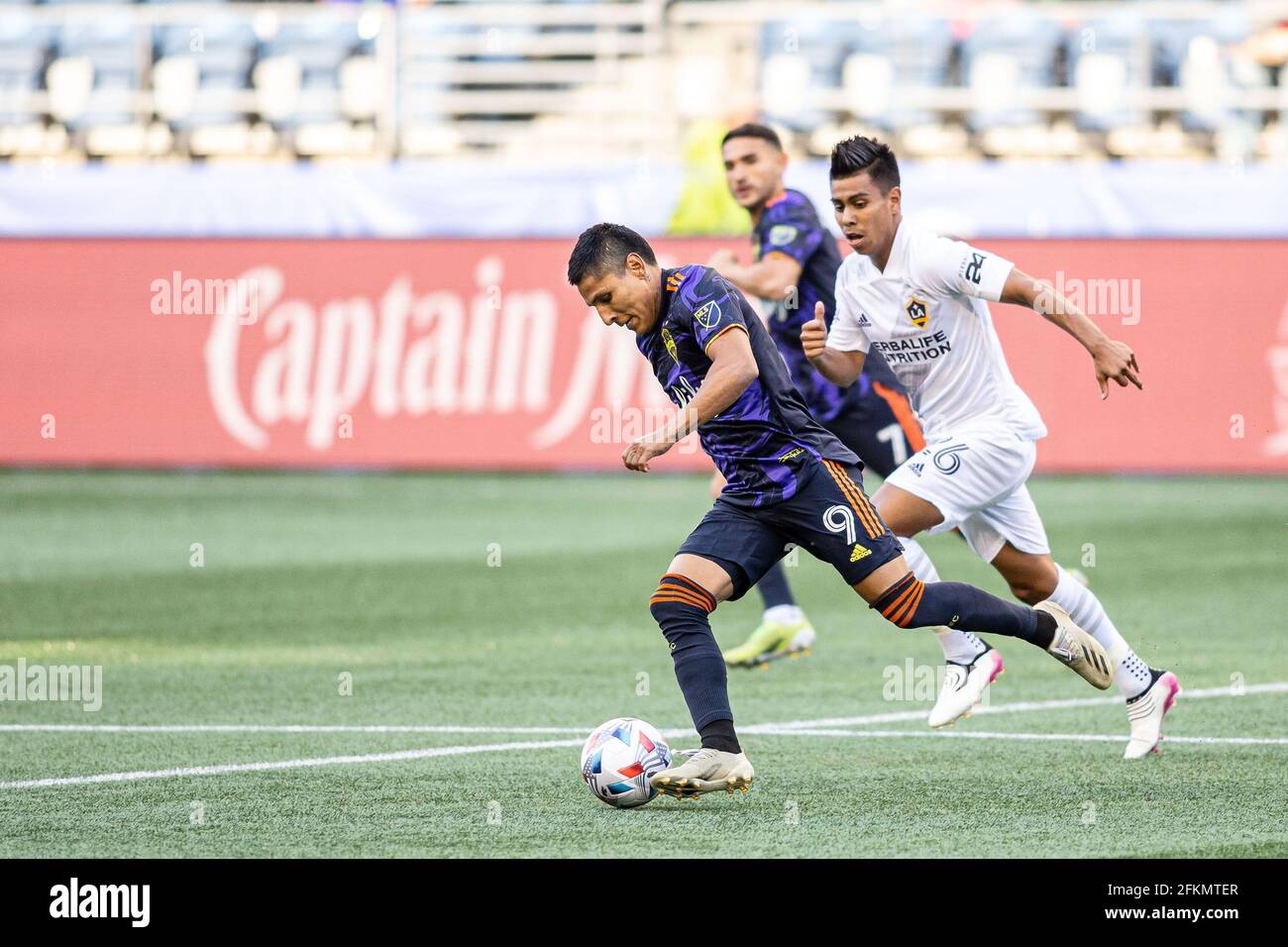 Seattle Sounders forward Raul Ruidiaz (9) controlling the ball against LA Galaxy midfielder Efrain Alvarez (26) during the first half of an MLS match Stock Photo