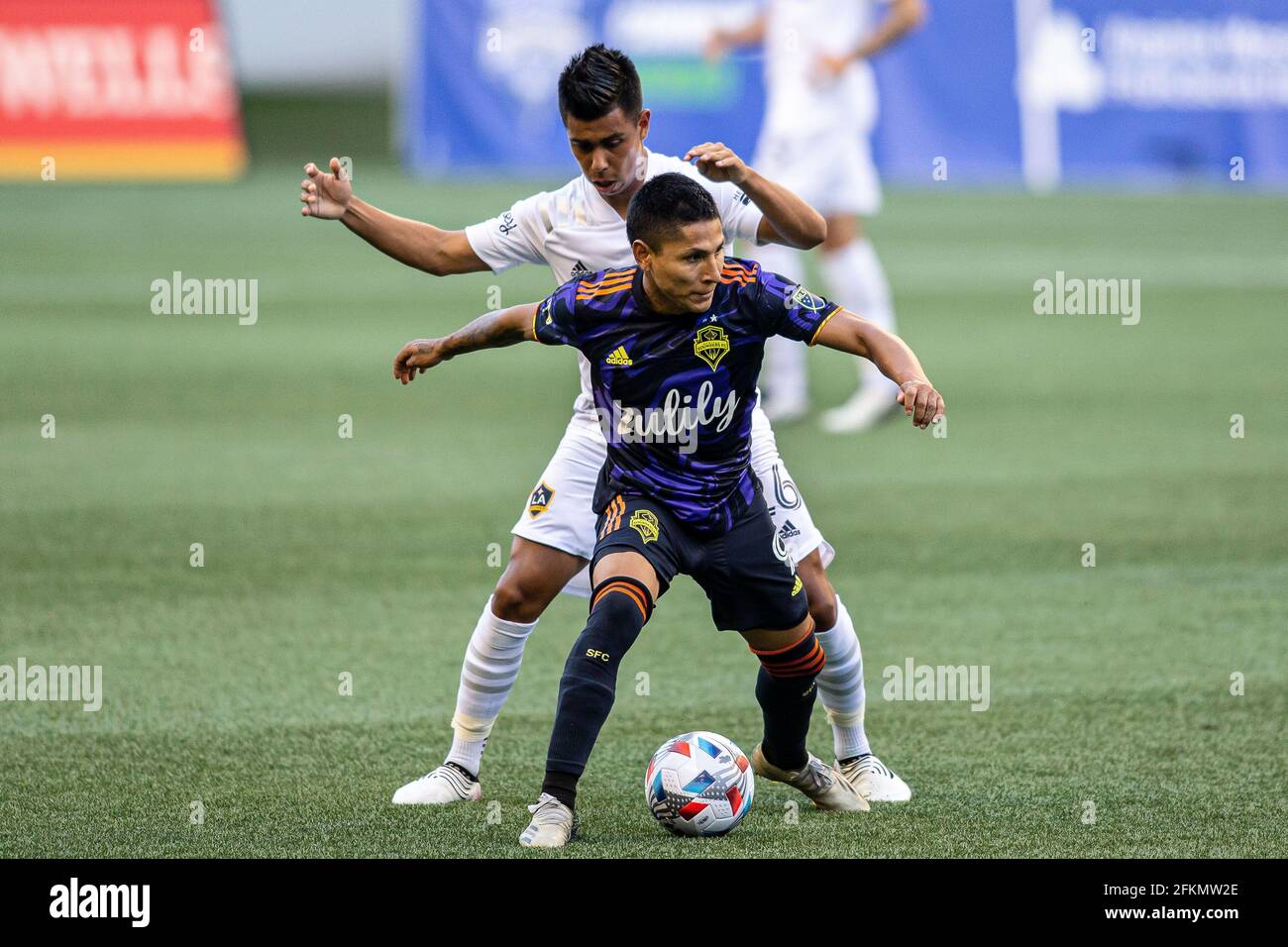 Seattle Sounders forward Raul Ruidiaz (9) boxing out LA Galaxy midfielder Efrain Alvarez (26) during the first half of an MLS match at Lumen Field, Tu Stock Photo