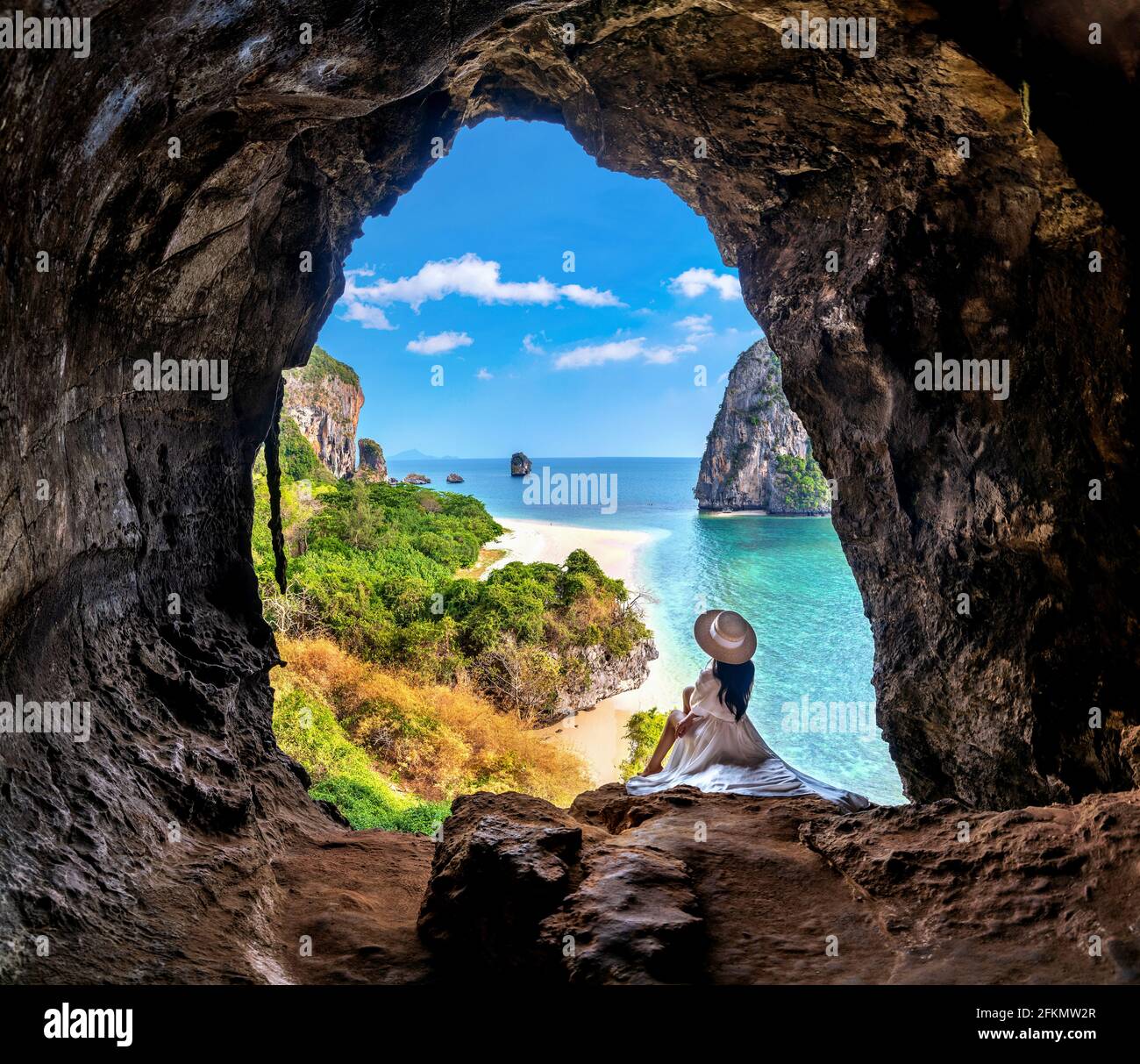 Woman sitting in the cave at Railay, Krabi, Thailand. Stock Photo