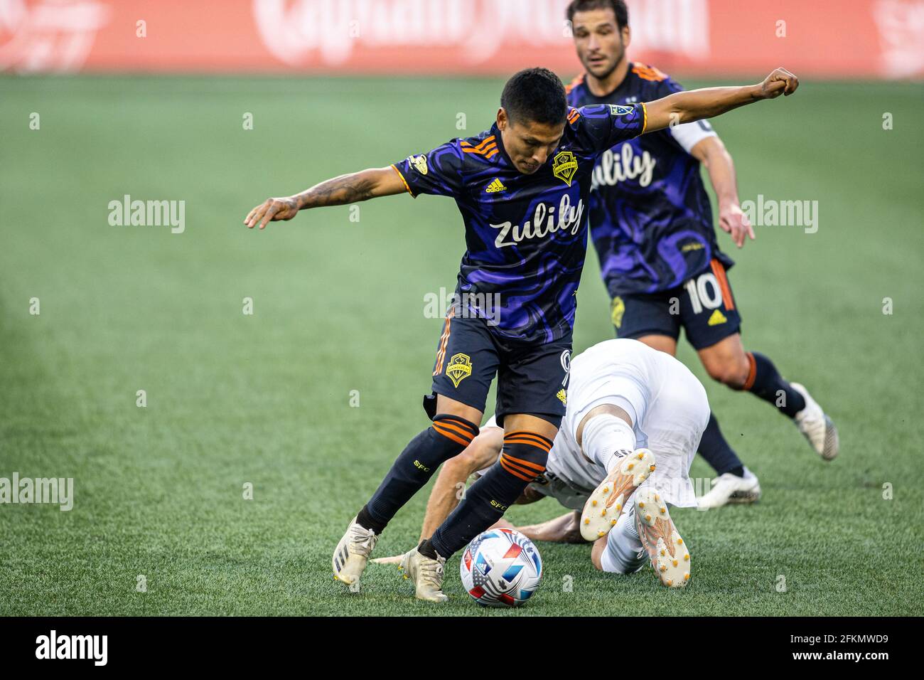 Seattle Sounders forward Raul Ruidiaz (9) keeping the ball away from LA Galaxy forward Nick DePuy (20) during the second half of an MLS match at Lumen Stock Photo