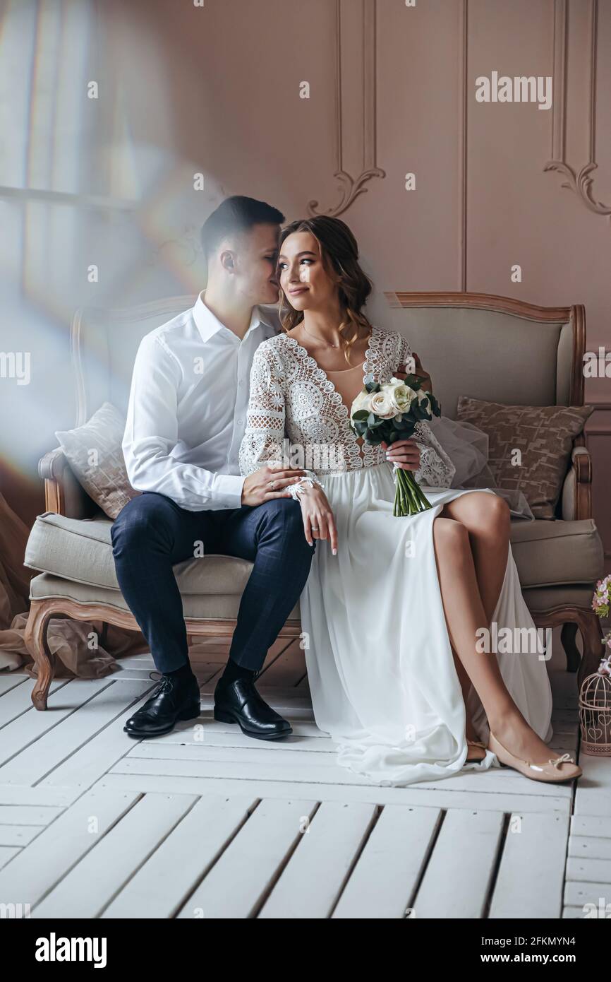Gentle portrait of the bride and groom in a lace wedding dress in boho style. Wedding photo session in the studio Stock Photo Alamy