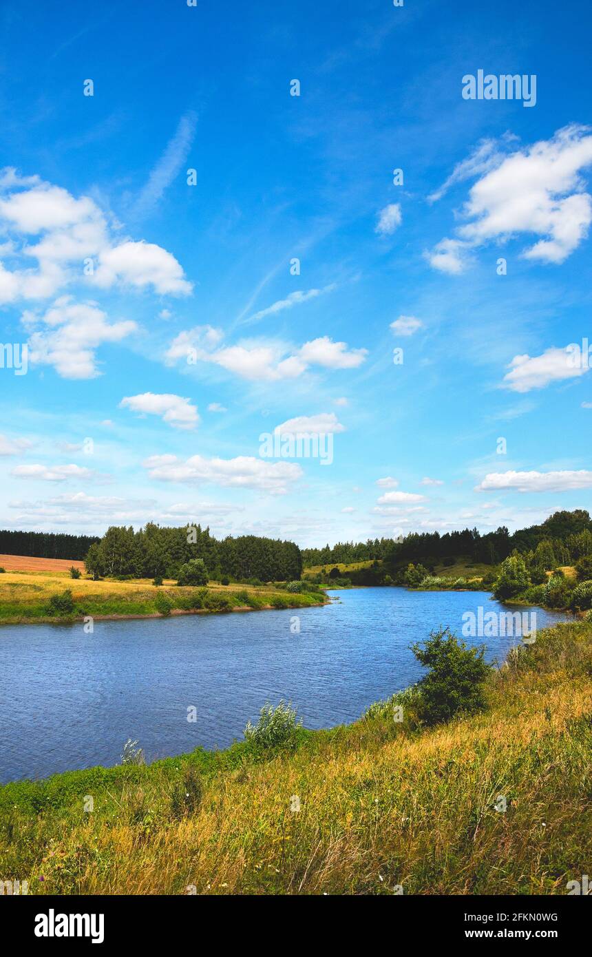 Beautiful view and landscape with green hills and green woods during sunny summer day. Stock Photo