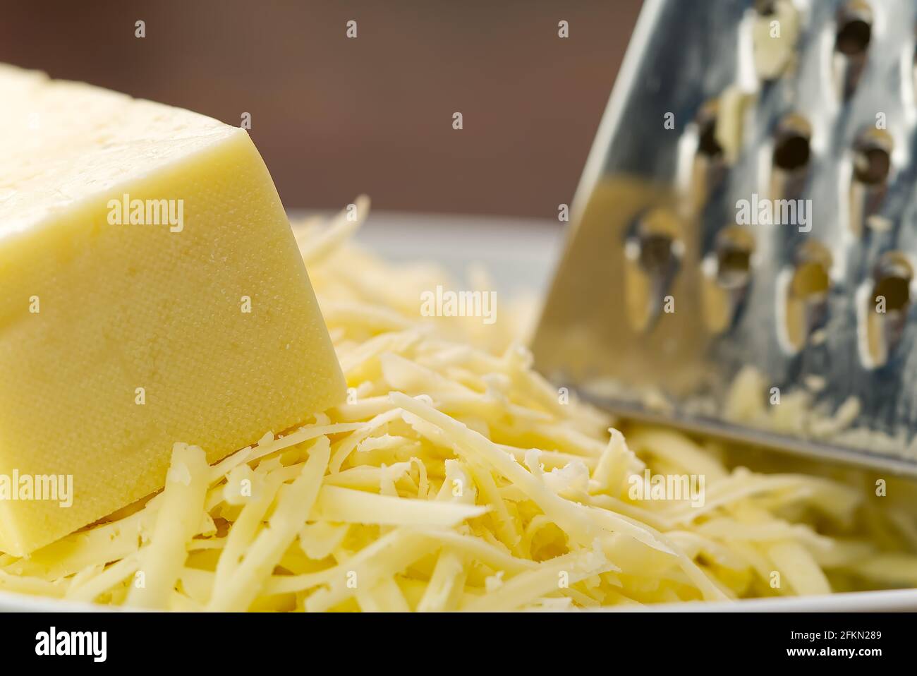 Cheese and Grated cheese, close-up. blurred background Stock Photo